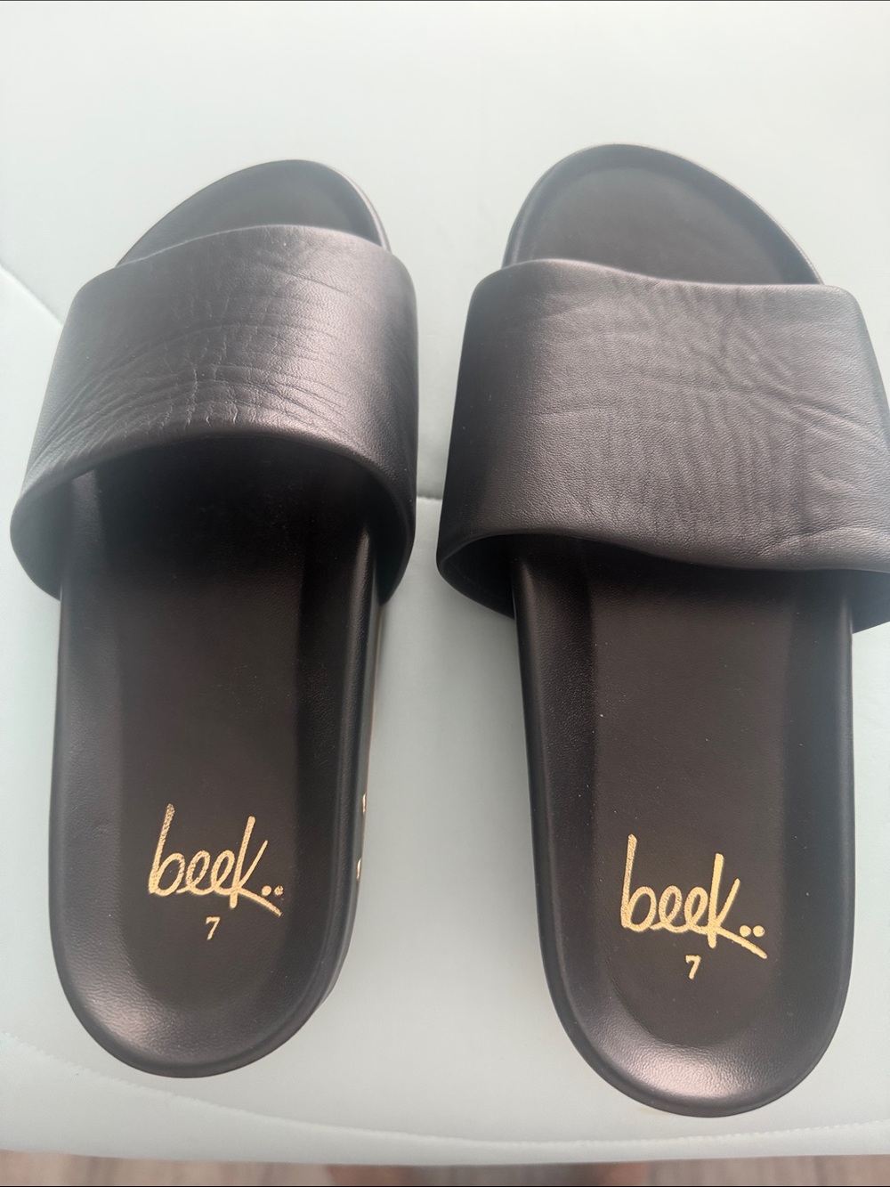 beek Black Slide Sandals with Gold Logo Accent